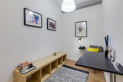 a living room with a table and a couch at Julius Caesar Home in Rome