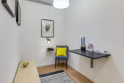 a desk in a room with a chair and a table at Julius Caesar Home in Rome