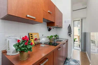 a kitchen with wooden cabinets and a counter top at Julius Caesar Home in Rome
