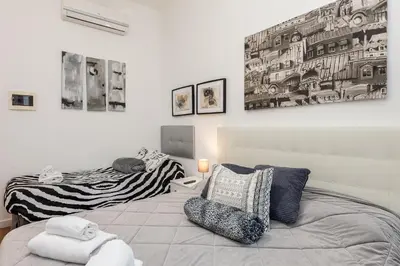 a bedroom with a bed and a chair in it at Julius Caesar Home in Rome
