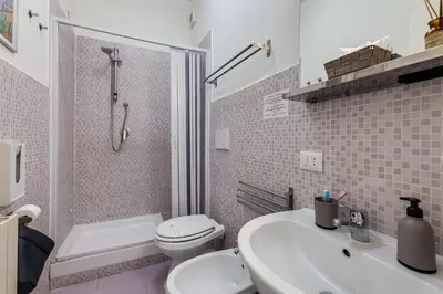 a bathroom with a toilet and a sink and a shower at Julius Caesar Home in Rome