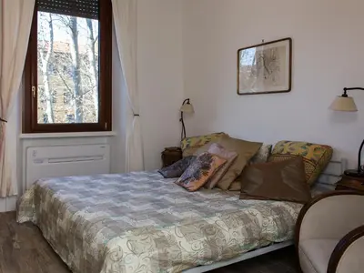 a bedroom with a bed and a window at The Apartments - Vatican in Rome