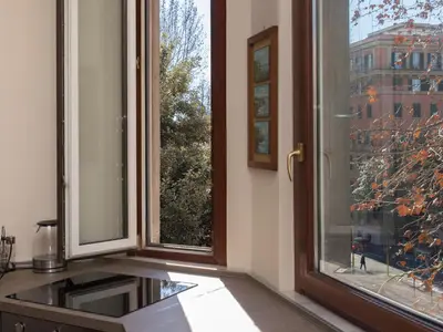 a kitchen with a window with a view of a building at The Apartments - Vatican in Rome