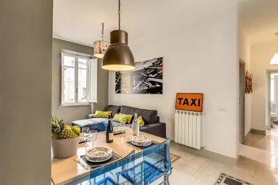 a living room with a table and a couch at Monti Coliseum Apartment in Rome