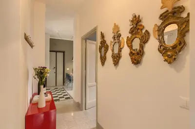 a hallway with gold framed mirrors on the wall at Monti Coliseum Apartment in Rome