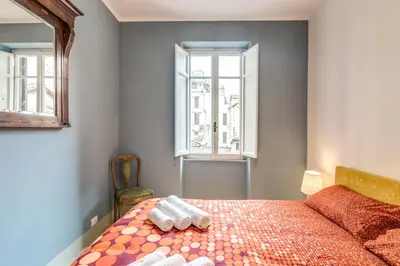 a bedroom with a bed with two towels on it at Monti Coliseum Apartment in Rome