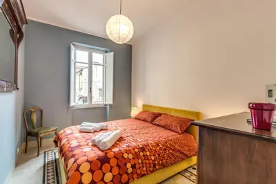 a bedroom with a bed with two towels on it at Monti Coliseum Apartment in Rome