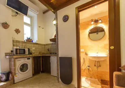 a bathroom with a sink and a washing machine at Underground Rome's Room in Rome