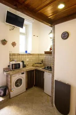 a kitchen with a washing machine and a sink at Underground Rome's Room in Rome