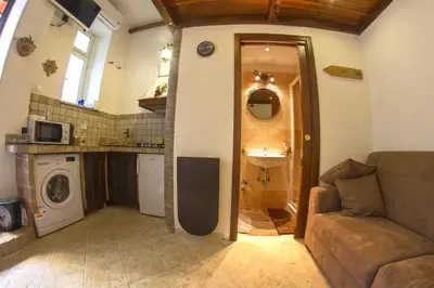 a living room with a couch and a sink at Underground Rome's Room in Rome