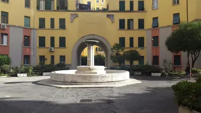 a fountain in a courtyard in front of a building at Underground Rome's Room in Rome