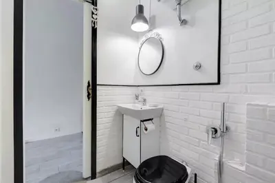 a white bathroom with a sink and a mirror at Moonlight Inn Guesthouse in Rome