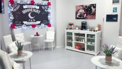 a room with white chairs and a table and a counter at Moonlight Inn Guesthouse in Rome