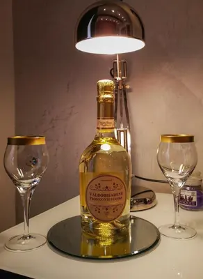 a bottle of wine on a table with two glasses at Moonlight Inn Guesthouse in Rome