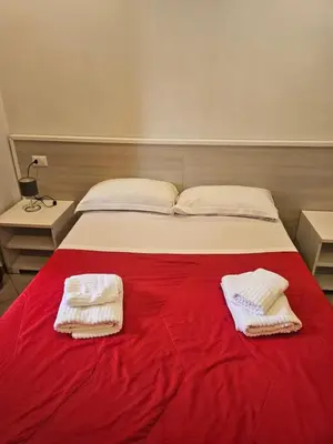 a bed with two towels on a red blanket at Wonderful Time Rome in Rome