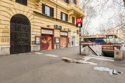 a building with a sign on the side of a street at Wonderful Time Rome in Rome