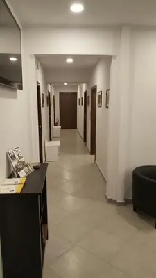 a hallway in a building with a desk and chairs at Wonderful Time Rome in Rome