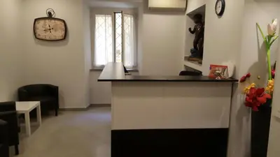 a room with a counter and a clock on the wall at Wonderful Time Rome in Rome