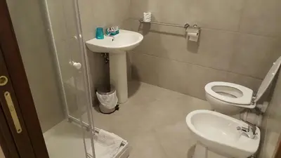 a bathroom with a toilet and a sink and a shower at Wonderful Time Rome in Rome