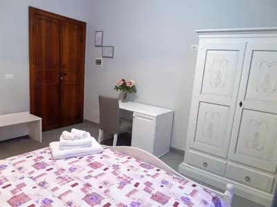 a bedroom with a bed and a desk and a table at 325 Rooms ai Fori in Rome