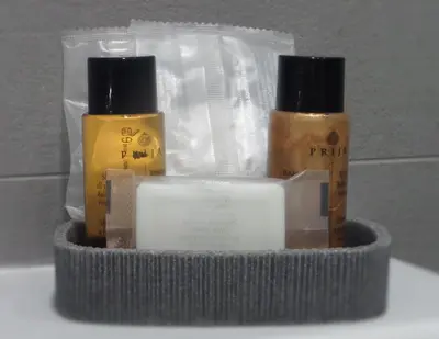 a container with three bottles of soap and other items at 325 Rooms ai Fori in Rome