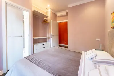 a bedroom with a large bed and a window at Atmosphera Trastevere, Glamour apartment in the center in Rome