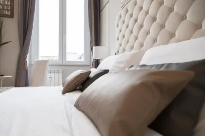 a bedroom with a large white bed with pillows at Corso Experience in Rome