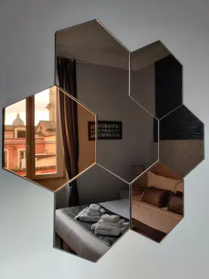 a reflection of a room with a bed and a mirror at Corso Experience in Rome