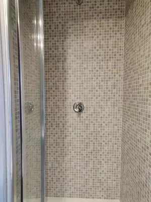 a shower stall with a glass door with a shower at Corso Experience in Rome