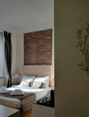 a bedroom with a large bed with white pillows at Corso Experience in Rome