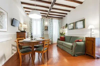 a living room with a table and a couch at Rome as you feel - Piazza dei Satiri apartments in Rome