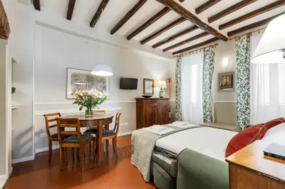 a bedroom with a bed and a table and chairs at Rome as you feel - Piazza dei Satiri apartments in Rome