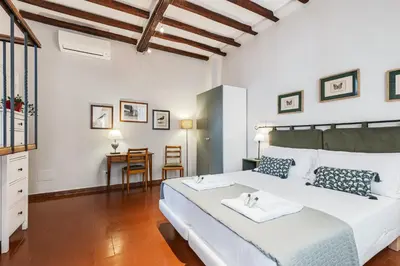 a bedroom with a large white bed and a table at Rome as you feel - Piazza dei Satiri apartments in Rome
