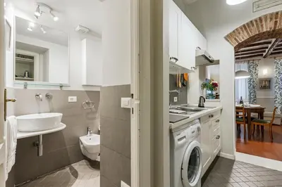 a bathroom with a sink and a washing machine at Rome as you feel - Piazza dei Satiri apartments in Rome