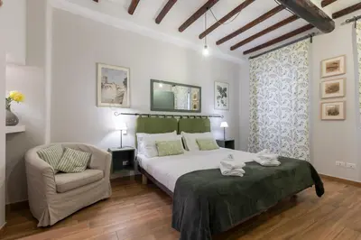 a bedroom with a bed and a chair at Rome as you feel - Piazza dei Satiri apartments in Rome