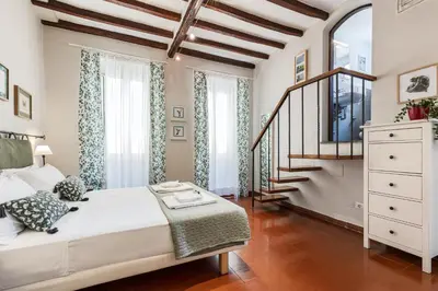 a bedroom with a large bed and a staircase at Rome as you feel - Piazza dei Satiri apartments in Rome