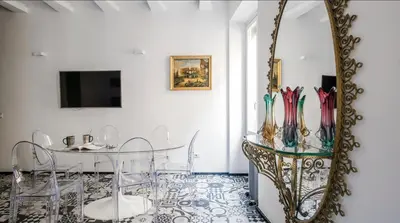 a dining room with a table and a mirror at Navona Hi-Tech Apartment in Rome