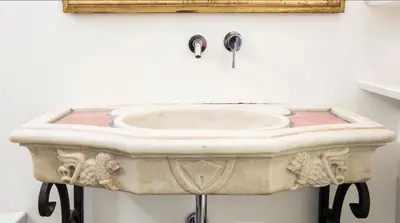 a bathroom with a stone sink on a wall at Navona Hi-Tech Apartment in Rome