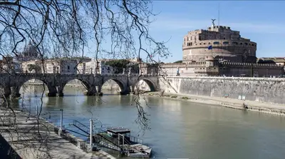a bridge over a river in front of a building at Navona Hi-Tech Apartment in Rome