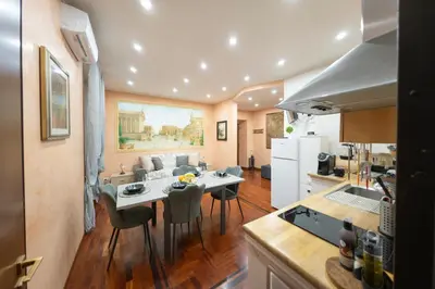 a kitchen and living room with a table and chairs at ROMA18 in Rome