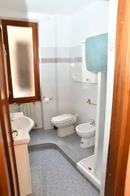 a bathroom with two toilets and a sink at ROMA18 in Rome