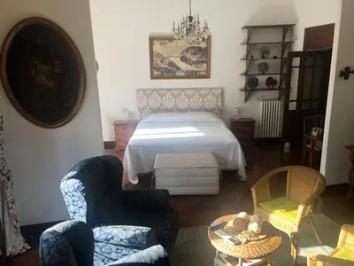 a bedroom with a bed and two chairs and a table at Catherine's Home in Rome