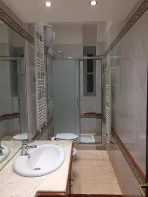 a bathroom with two toilets and a sink and a shower at Catherine's Home in Rome