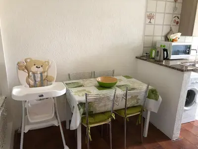 a small kitchen with a table with a teddy bear on it at Catherine's Home in Rome