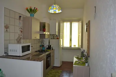 a kitchen with a white microwave and a refrigerator at Catherine's Home in Rome