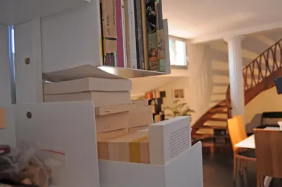 a stack of boxes in a living room with a staircase at La Mia Casa in Campo di Fiori in Rome