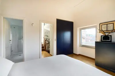 a bedroom with a white bed and a window at La Mia Casa in Campo di Fiori in Rome