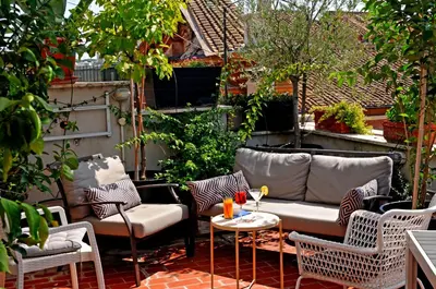 a patio with a couch and chairs and a table at La Mia Casa in Campo di Fiori in Rome