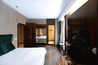 a bedroom with a bed and a flat screen tv at The Babuino - Luxury serviced apartment in Rome