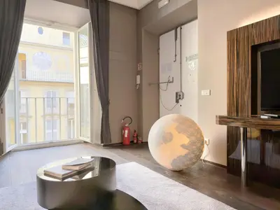 a living room with a television and a globe on the floor at The Babuino - Luxury serviced apartment in Rome